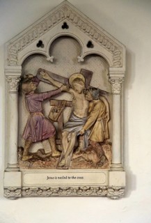 Jesus is nailed to the Cross, stations of the cross, Ufford church, Suffolk, England, UK