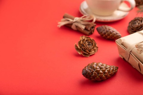 Christmas or New Year composition. Decorations, box, cinnamon, cones, fir and spruce branches, cup