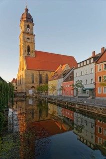 Gentle morning light falls on a historic city view with the church tower of St Martin's Basilica,