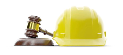Yellow hard hat and gavel isolated on a white background