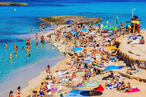 Bathers and sunbathers on the beach of Cala Comte bay, Ibiza, Balearic Islands, Mediterranean Sea,