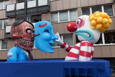 Behind the mask of the AFD is the skull of Hitler, papier-mâché figures, satirical float by Jacques