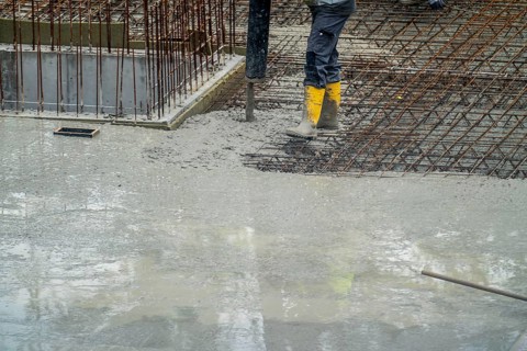 Construction site, concreting, the floor slab of a building is concreted, the concrete is pumped