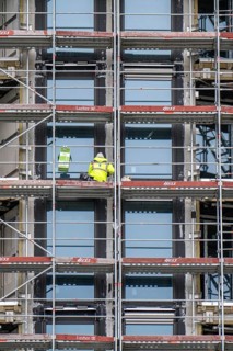 Large construction site, construction of a residential building with many flats, scaffolding,