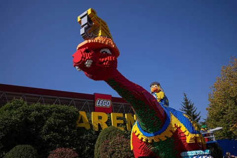Dinosaurs in front of LEGO Arena, LEGOLAND theme park, Germany, Logo, Günzburg, Bavaria, Germany,