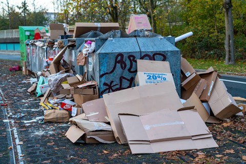 Overfilled waste paper containers, despite the overcrowding, people have put their waste paper next