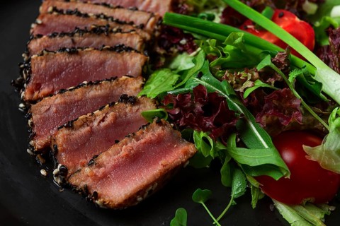 Vegetable salad, with fried tuna, in sesame seeds, healthy food, top view