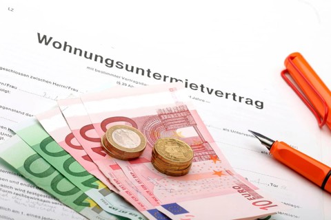 A rental agreement with euro banknotes and coins, studio