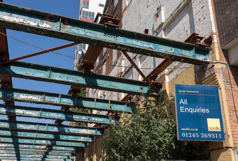 Savills estate agent sign All Enquiries on derelict factory building, Wet Dock, Ipswich, Suffolk,