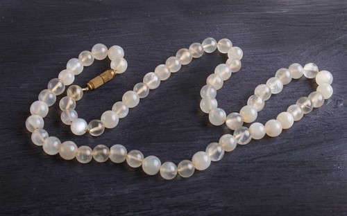 Agate colored beads on a black background. top view, close up