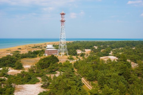 Marine radio tower, sandy coastal landscape with sandy beach, dunes and sparse vegetation, sand