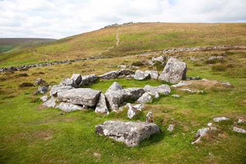 Ruins of stone hut circle in the Neolithic enlcosed area of Grimspound, Dartmoor national park,