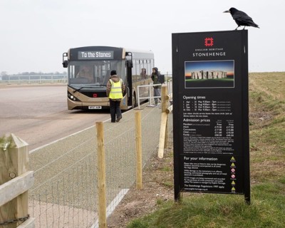 English Heritage admission prices sign and visitor bus transport to and from the Stones,