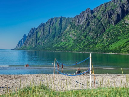 Beach Ersfjordstranden, fjord Ersfjord, public recreation area, summer, people go swimming, view to