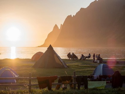 Beach Ersfjordstranden, fjord Ersfjord, people sitting in small groups at the beach, public