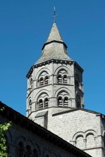 Orcival. Bell tower of the Notre-Dame d'Orcival basilica showcasing Romanesque architecture under a