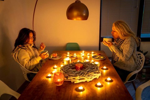 Symbolic image energy saving, cold winter, energy crisis, cold flat, mother and daughter dressed