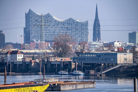 Hamburg harbour, Travehafen, water police station 2, working boats and barges, jetty, city skyline