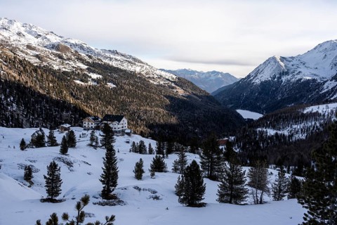 Zufallhütte mountain hut, view of the Martell Valley, snow-covered mountain landscape in winter,