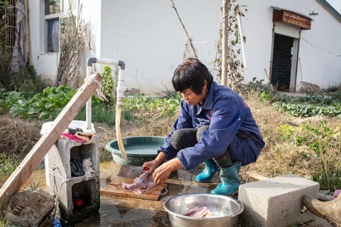 Lu Jua Ling prepares a duck for her colleagues to eat, Duck Breeding Centre Jiang Su Xiang Gui