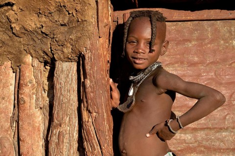 Himba girl at the door of her hut, Omohanja, Kaokoland, Kunene, Namibia, Africa