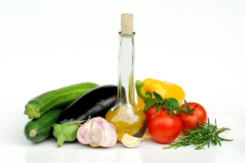 Ingredients for ratatouille, zucchini, aubergines, garlic, olive oil, tomatoes, rosemary, basil
