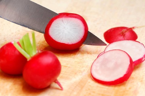 Red Radish (Raphanus sativus var. sativus) are cut, cut, knife