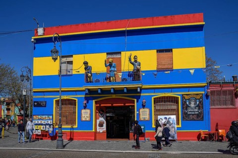 Colourful house facade, on the balcony footballer Diego Maradona, folk heroine Eva Perón and tango