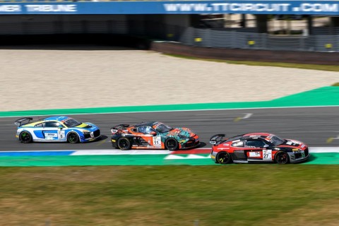 Three race cars sports car in the back front Audi R8 LMS GT4 with Porsche Cayman GT4 Clubsport