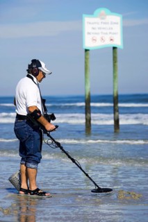 Man with metal detector, Daytona Beach, Florida, USA, North America