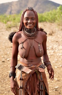 Young Himba woman with traditional jewellery, Ombombo, Kaokoland, Kunene, Namibia, Africa