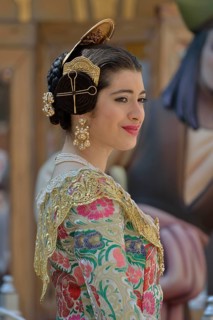 Fallas festival, woman in a traditional costume during the parade in the Plaza de la Virgen de los