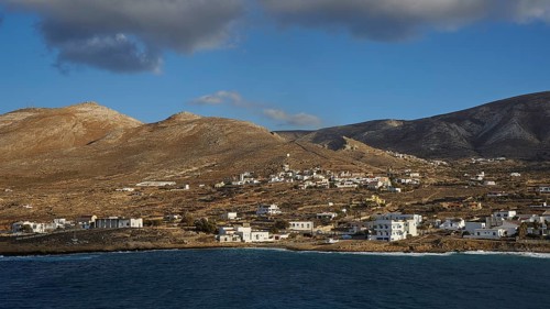 View of a coastal village with hills in the background and blue sky, Kassos Island, neighbouring