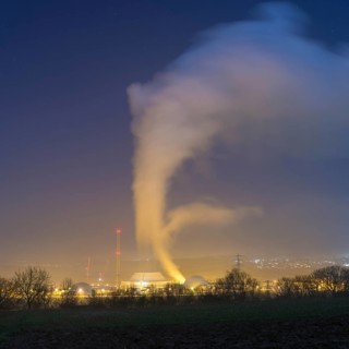 Industrial environment at night with rising clouds of smoke, Neckarwestheim nuclear power plant,