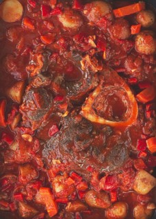 Ossobuco stew with vegetables, knuckle on the bone with new potatoes, in tomato sauce, homemade,