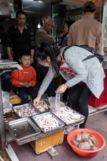 Stall selling duck giblets, including dried duck blood, an inexpensive foodstuff that is very