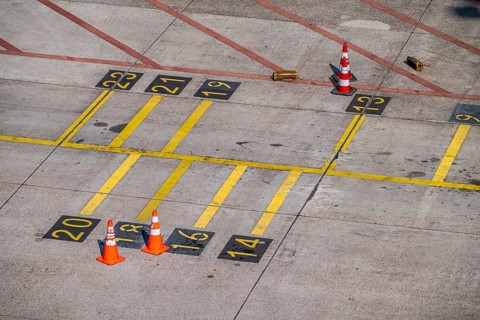 Park markings on the ground, at the terminal, in front of the passenger boarding bridge, holding