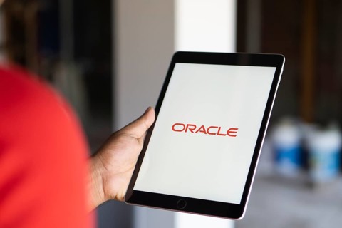 ORACLE logo displayed on smartphone screen. ORACLE is a multinational computer technology