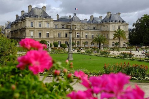 In the Jardin du Luxembourg: well-tended park with lush flowers, the Palais du Luxembourg in the