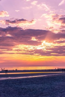 Beautiful Sunset at the Seaside with golden light and Violet clouds