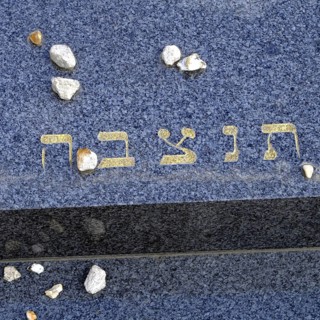 Jewish gravestone with small stones left behind, signalling that the deceased is not forgotten.