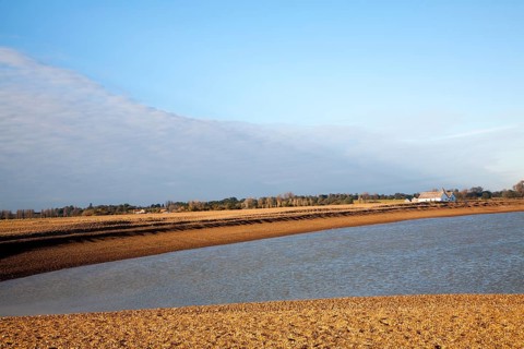 Seaside bungalow on shingle beach near North Weir Point, Shingle Street, Suffolk, England, UK