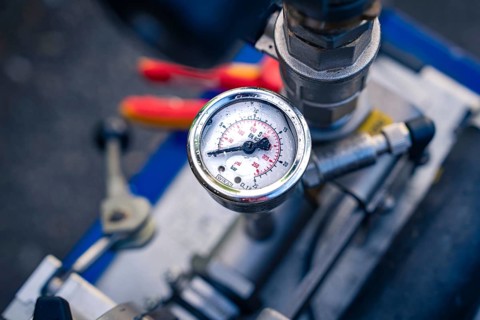 A detailed view of a round pressure gauge on a machine, glass fibre construction, Nagold, Black