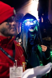 Person with glowing glasses and witch mask at a night carnival party, carnival, Schellbronn night