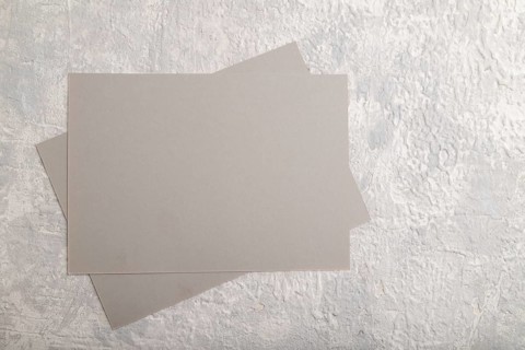 Gray paper business card, mockup on gray concrete background. Blank, flat lay, top view, still