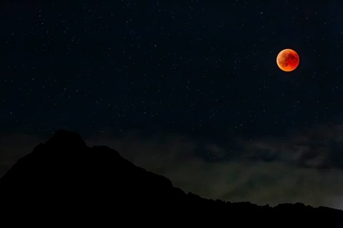 Complete lunar eclipse in front of mountains at night, full moon, Karwendel Mountains, Bavaria,