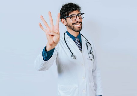 Doctor counting number four isolated. Handsome doctor counting number 4 on isolated background