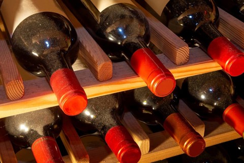Wine cellar with red wine bottles