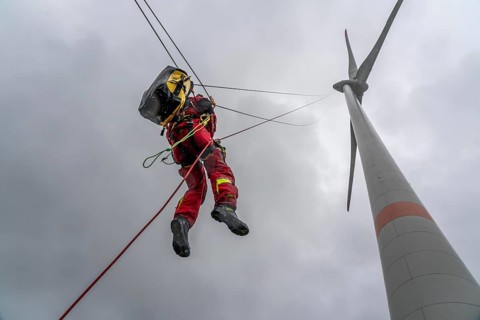 Height rescuers from the Oberhausen fire brigade practise abseiling from a wind turbine from a