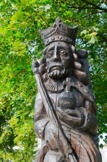 Wooden sculpture of a crowned king under green leaves, skilfully and richly detailed, Casimir I